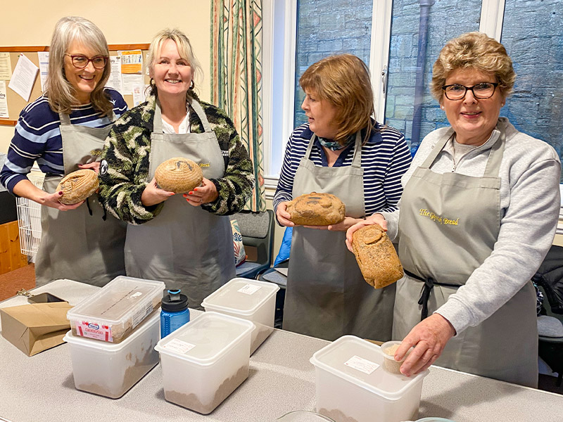  attendees with loaves dough starter to take home from classes