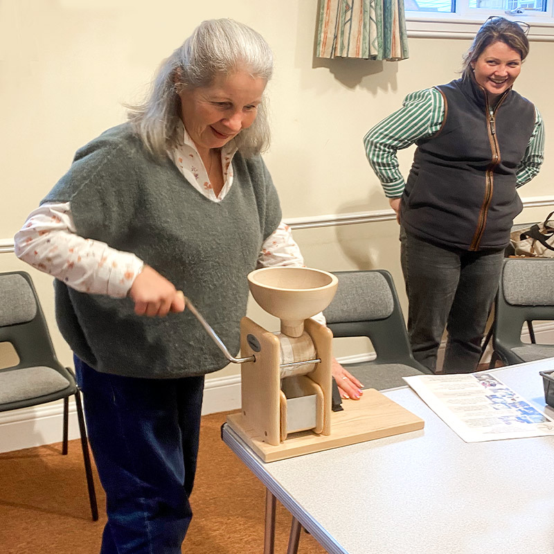 lady using hand stone grinder in sourdough class